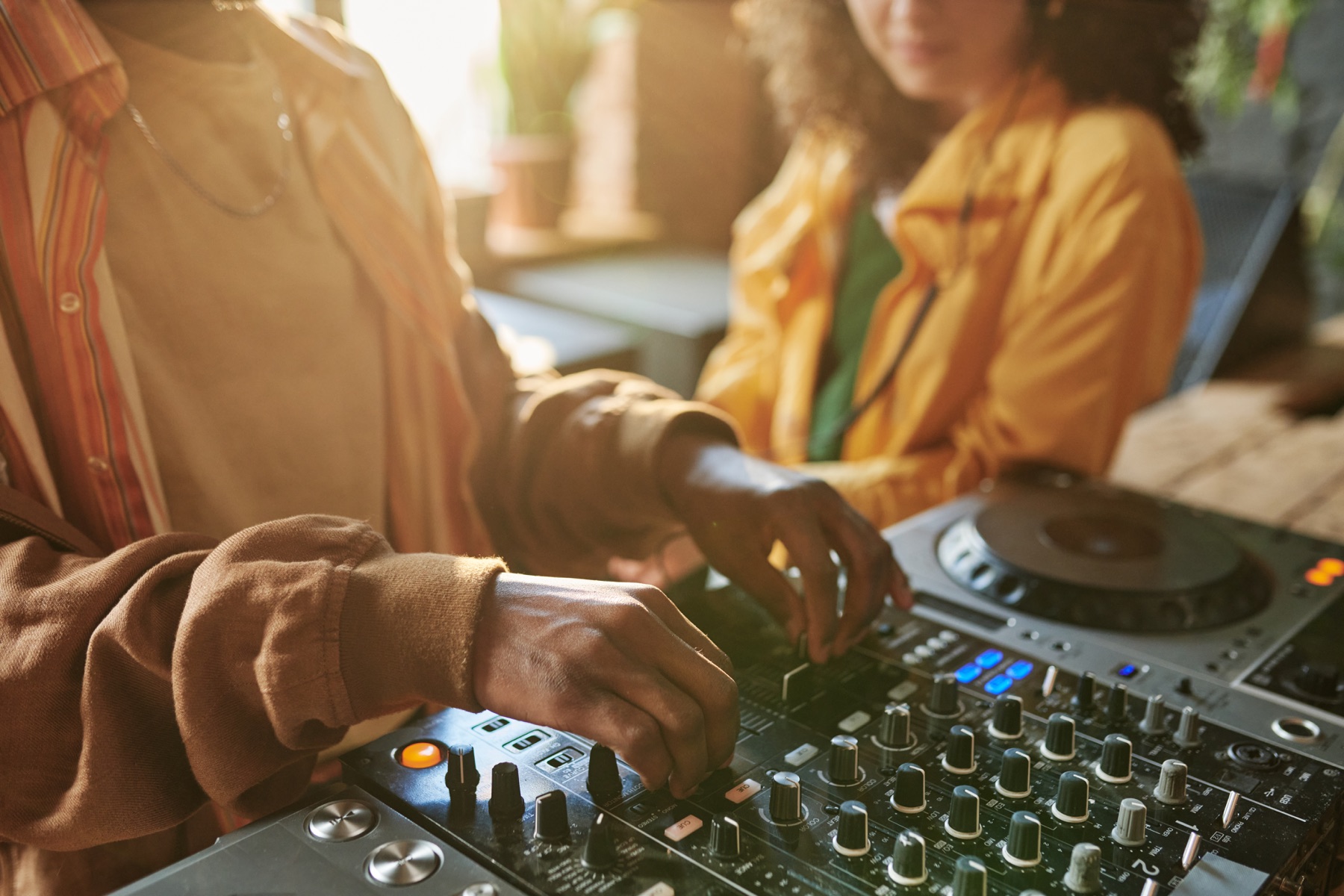 DJ shaping a mix on a professional controller